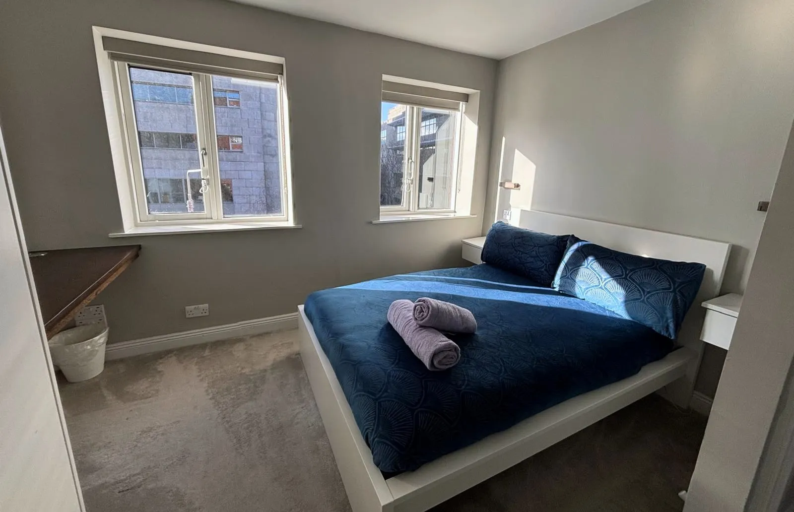 Double bedroom made up with fresh towels after a turnover clean